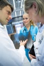 Medical team discussing over x-ray report in corridor Royalty Free Stock Photo