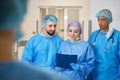 Medical team discussing while standing in hospital Royalty Free Stock Photo