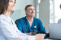 Medical Team Discussing Treatment Options With Patients. Team of doctors having a meeting in the meeting room. Royalty Free Stock Photo