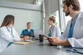 Medical Team Discussing Treatment Options With Patients. Team of doctors having a meeting in the meeting room. Royalty Free Stock Photo