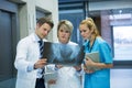 Medical team examining x-ray report in corridor Royalty Free Stock Photo