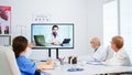 Medical team holding online conference in boardroom Royalty Free Stock Photo