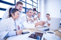 Medical team looking into laptop and having a discussion Royalty Free Stock Photo