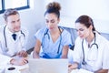 Medical team looking into laptop and having a discussion Royalty Free Stock Photo