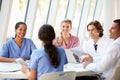 Medical Team Meeting Around Table In Modern Hospital Royalty Free Stock Photo