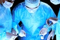 Medical team performing operation. Group of surgeon at work in operating theatre toned in blue Royalty Free Stock Photo