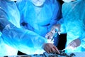 Medical team performing operation. Group of surgeon at work in operating theatre toned in blue Royalty Free Stock Photo