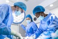 Medical team performing operation. Group of surgeon at work in operating theatre toned in blue. Doctor operation in operation room Royalty Free Stock Photo