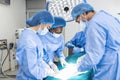 Medical team performing operation. Group of surgeon at work in operating theatre toned in blue. Doctor operation in operation room Royalty Free Stock Photo