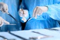 Medical team performing operation. Group of surgeon is working in operating theatre toned in blue Royalty Free Stock Photo