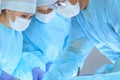 Medical team performing operation. Three of surgeons at work are busy of patient. Medicine, veterinary or healthcare and Royalty Free Stock Photo