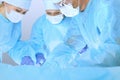 Medical team performing operation. Three of surgeons at work are busy of patient. Medicine, veterinary or healthcare and Royalty Free Stock Photo