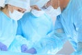 Medical team performing operation. Three of surgeons at work are busy of patient. Medicine, veterinary or healthcare and Royalty Free Stock Photo