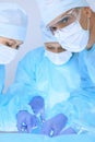 Medical team performing operation. Three of surgeons at work are busy of patient. Medicine, veterinary or healthcare and Royalty Free Stock Photo