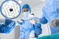 Medical Team Performing Surgical Operation in Bright Modern Operating Room. Group of surgeons at work in operating theater toned Royalty Free Stock Photo