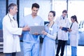 Medical team using laptop, digital tablet and examining medical report Royalty Free Stock Photo