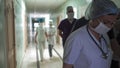 Medical team walking together along hospital corridor. Group of doctors in hurry for surgery or for examination of Royalty Free Stock Photo