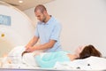 Medical technical assistant preparing scan of knee with MRI