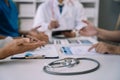 Medical technology concept. Doctor working with mobile phone and stethoscope and digital tablet laptop in modern office at Royalty Free Stock Photo