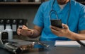 Medical technology concept. Doctor working with mobile phone and stethoscope and digital tablet laptop in modern office Royalty Free Stock Photo