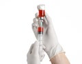 Medical theme: doctor's hand in a white glove holding a red vial of liquid for injection isolated on white background Royalty Free Stock Photo