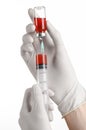 Medical theme: doctor's hand in a white glove holding a red vial of liquid for injection isolated on white background Royalty Free Stock Photo