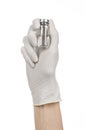 Medical theme: doctor's hand in a white glove holding a vial of clear liquid for injection isolated on white background Royalty Free Stock Photo