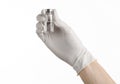 Medical theme: doctor's hand in a white glove holding a vial of clear liquid for injection isolated on white background Royalty Free Stock Photo