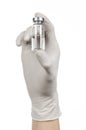 Medical theme: doctor's hand in a white glove holding a vial of clear liquid for injection isolated on white background