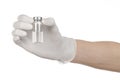 Medical theme: doctor's hand in a white glove holding a vial of clear liquid for injection isolated on white background Royalty Free Stock Photo