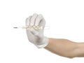 Medical theme: doctor's hand in white gloves holding a thermometer to measure the temperature of the patient on a white background Royalty Free Stock Photo