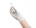 Medical theme: doctor's hand in white gloves holding a thermometer to measure the temperature of the patient on a white background Royalty Free Stock Photo