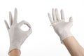 Medical theme: doctor's hand in white gloves holding a thermometer to measure the temperature of the patient on a white background Royalty Free Stock Photo