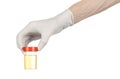 Medical theme: doctor's hand in white gloves holding a transparent container with the analysis of urine on a white background