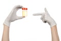 Medical theme: doctor's hand in white gloves holding a transparent container with the analysis of urine on a white background Royalty Free Stock Photo