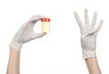 Medical theme: doctor's hand in white gloves holding a transparent container with the analysis of urine on a white background Royalty Free Stock Photo