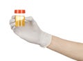 Medical theme: doctor's hand in white gloves holding a transparent container with the analysis of urine on a white background Royalty Free Stock Photo