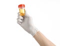 Medical theme: doctor's hand in white gloves holding a transparent container with the analysis of urine on a white background Royalty Free Stock Photo