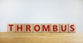 Medical and and thrombus symbol. Wooden cubes with the word `thrombus`. Beautiful white background. Medical and thrombus concept
