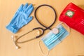 Medical tools such as stethoscope, gloves and a mask resting on a computer keyboard as a symbol of the reparation of laptops and d