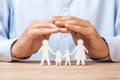 Medical or travel insurance. Man covers the family with his hands from his father, mother, son and daughter Royalty Free Stock Photo