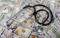 Medical treatment and cost concept: stethoscope placing on US dollars banknotes