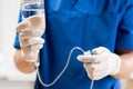 Doctor in blue uniform holding drip iv and infusion pump, . Intravenous fluid for seriously patient in the emergency Royalty Free Stock Photo