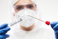 Medical UK healthcare technologist holding COVID-19 swab collection kit