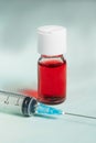 Syringe and phial with red liquid Royalty Free Stock Photo