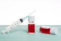 Syringe and ampules with red liquid Royalty Free Stock Photo