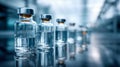Medical vials with clear liquid arranged in a line on reflective surface in laboratory setting with modern scientific background Royalty Free Stock Photo