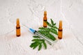 Medical vials for injection with a syringe and green leaf