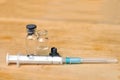 Medical vials for injection and syringe on wood table Royalty Free Stock Photo