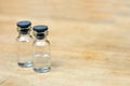 Medical vials for injection on wood table Royalty Free Stock Photo